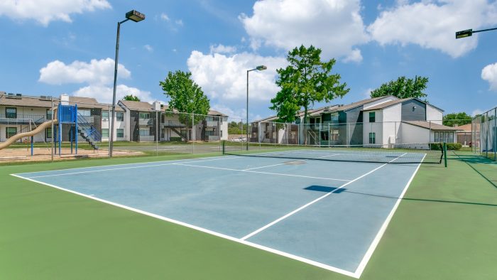 a tennis court with a fence around it at The  Holden